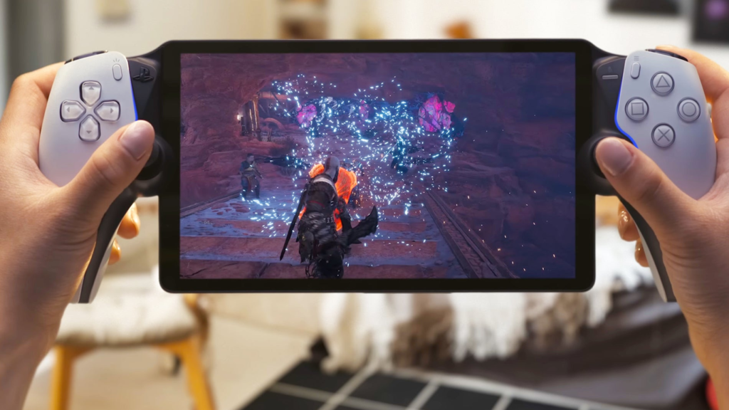 Pessoa segurando um console portátil da Sony com tela exibindo jogo de ação com efeitos de partículas e iluminação avançada em ambiente interno.